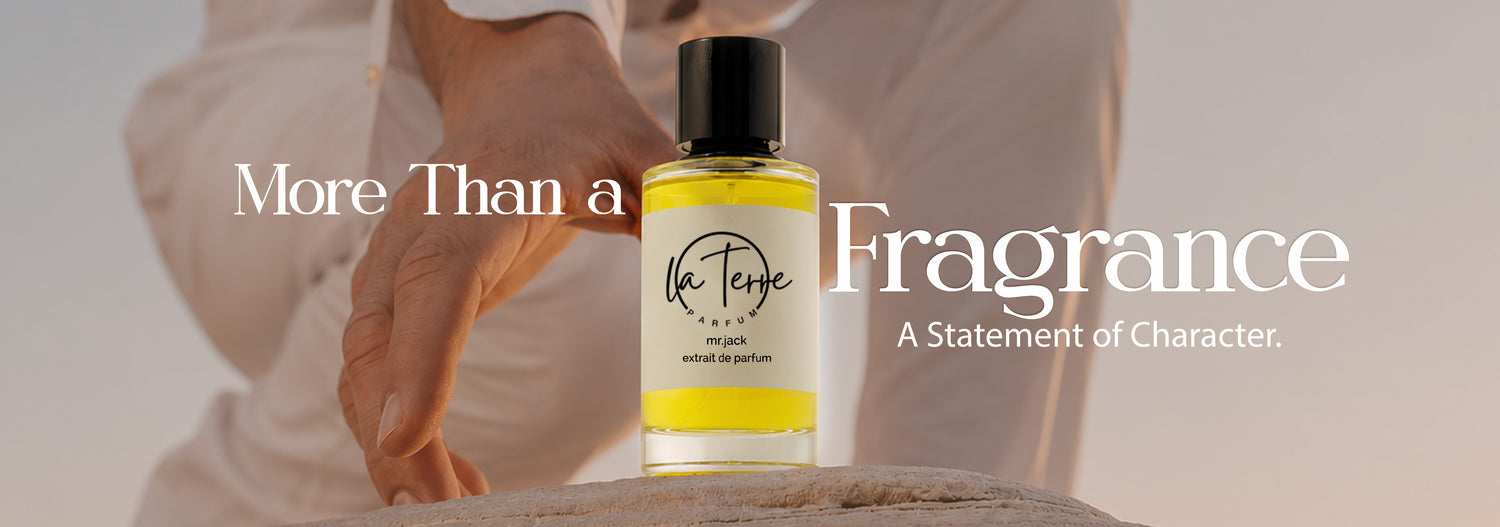 A small bottle of La Férie Organic perfume with a black cap and yellow liquid, held by a person in a cream-colored outfit against a soft beige background. Large white text on the left and right reads 'More Than a Fragrance' and 'A Statement of Character.